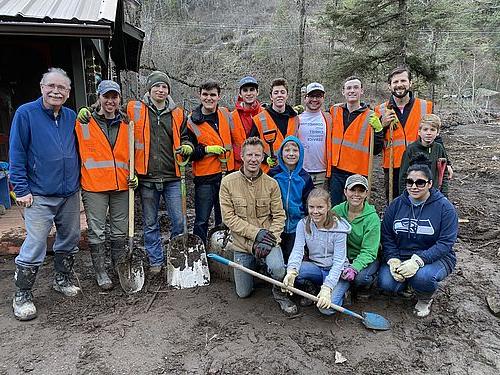 Students and Volunteers stand together in a group after a day of work.